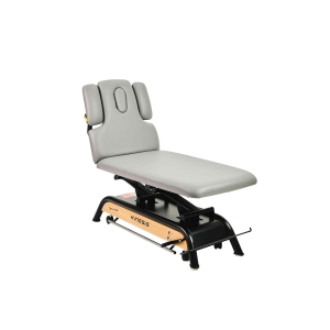 Milton MTR – elektryczny stół rehabilitacyjny z oparciem i regulowanymi zagłówkami bocznymi.